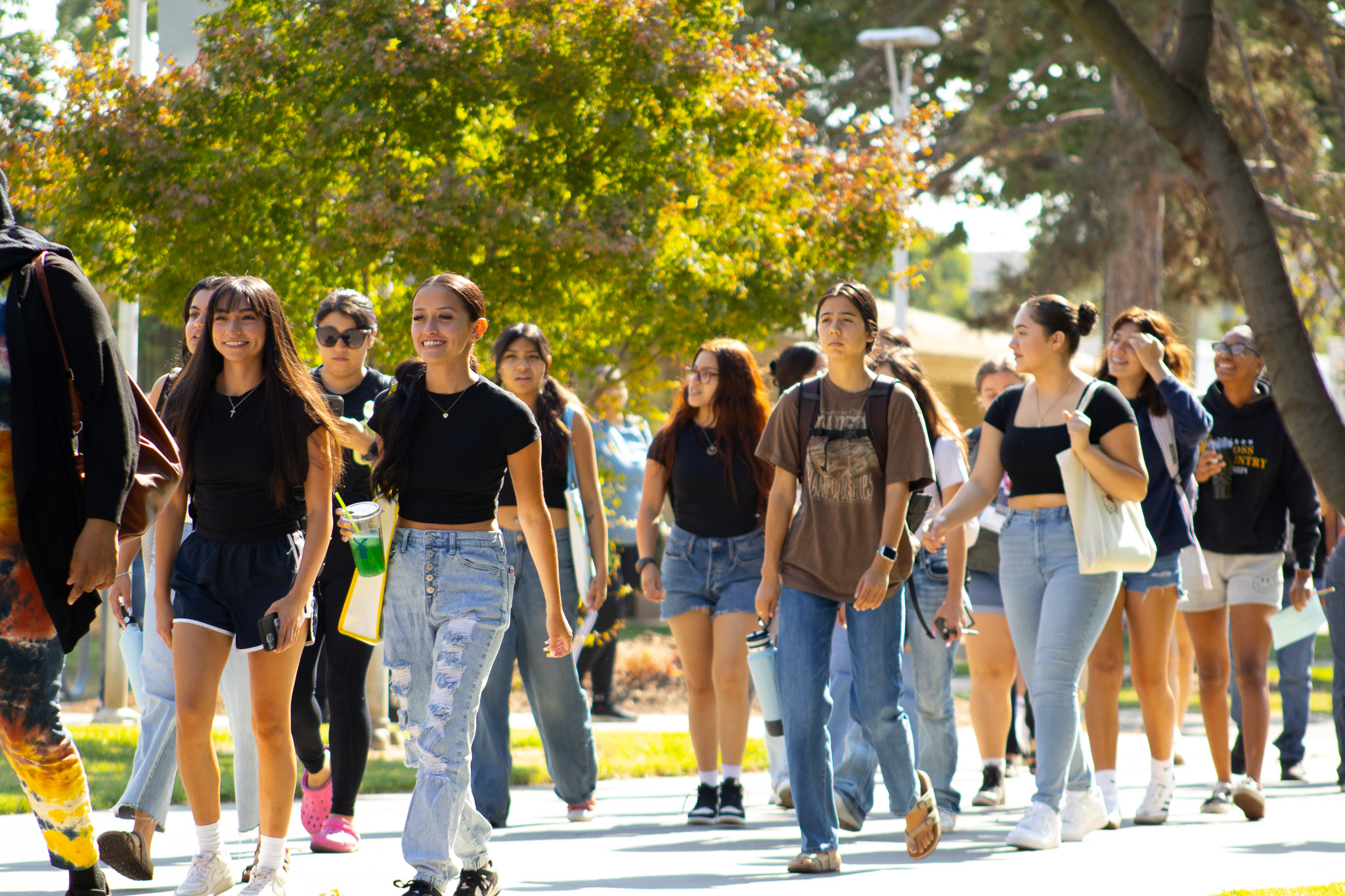 Students walking through campus in conversation.