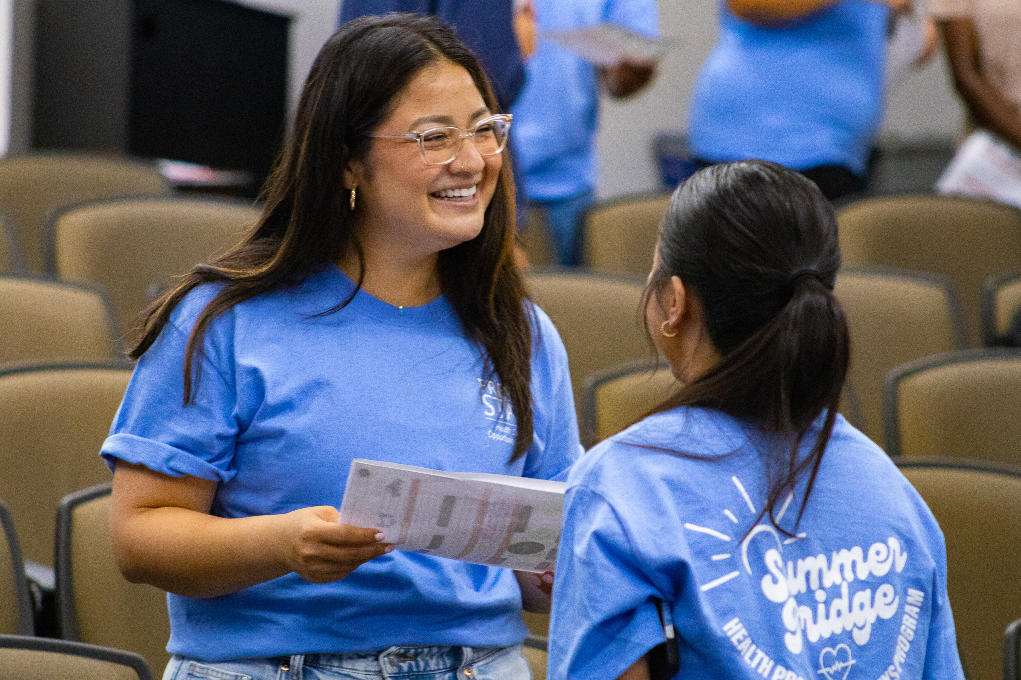 Two HPP students participating in an activity and laughing.