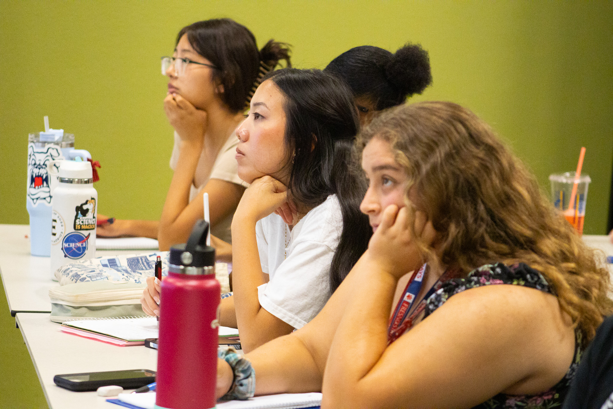 Three HPP students listening intently during a math lecture.